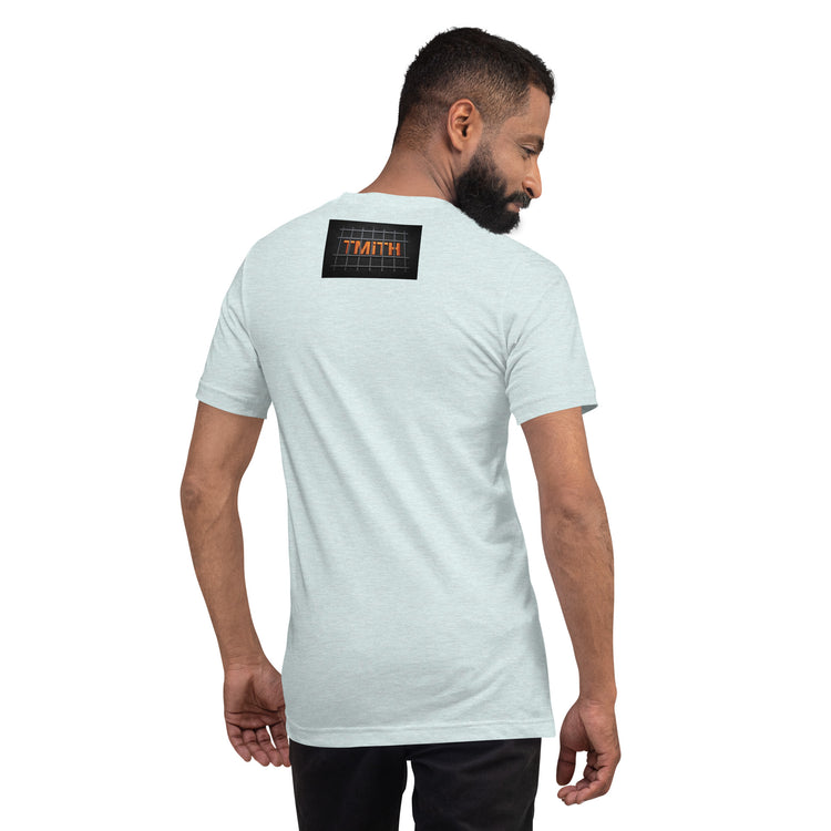 Model showing the back of a heather prism ice blue TMiTH T-shirt with orange lettering behind gray prison bars. The Man in The Hat 907 artist merch expressing You Are Not Alone message.