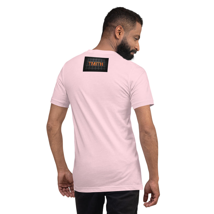 Model showing the back of a soft pink TMiTH T-shirt with orange lettering behind gray prison bars. The Man in The Hat 907 artist merch expressing complex PTSD handshake.